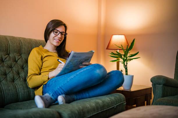 Person relaxing with crossword